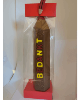 Potlood in melkchocolade met rode en gele letters "Bedankt"